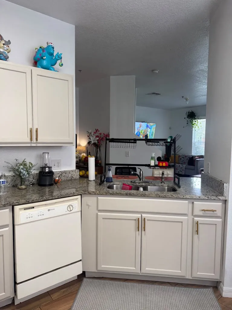 Cream painted kitchen cabinets with brass pulls