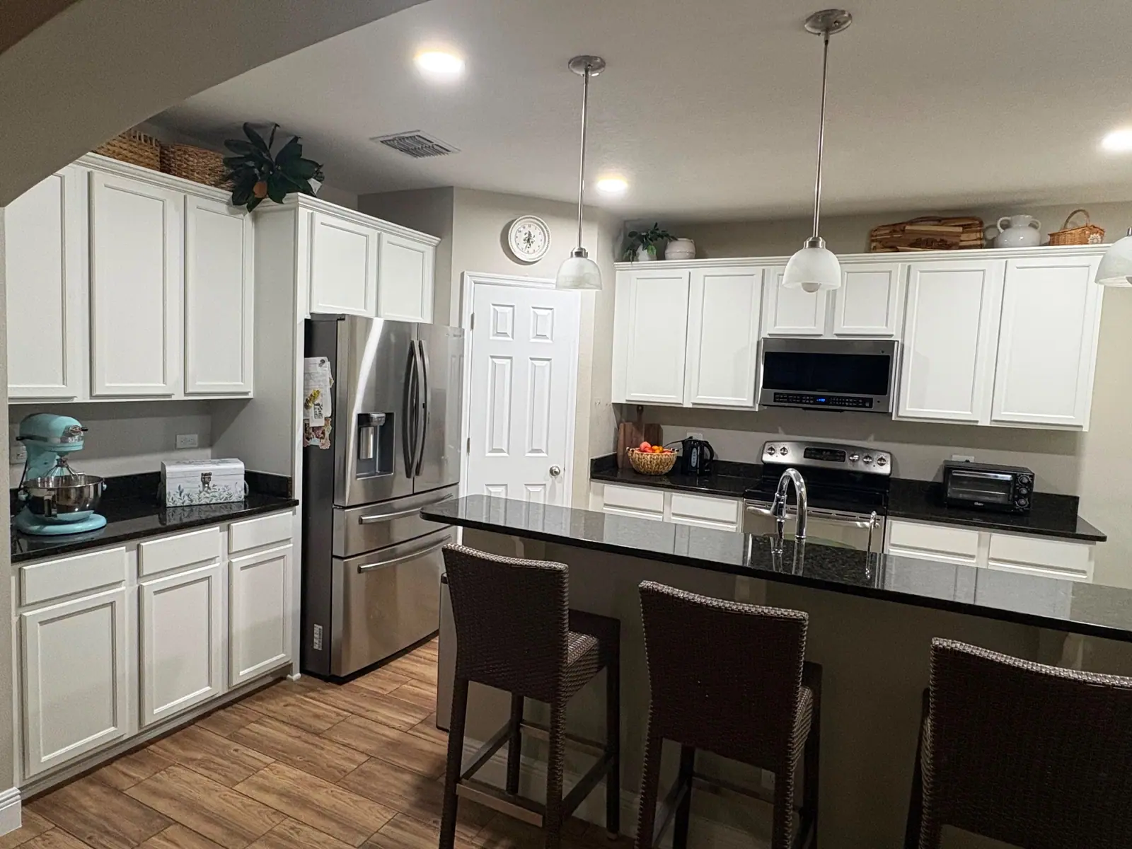 The same kitchen with the island painted white