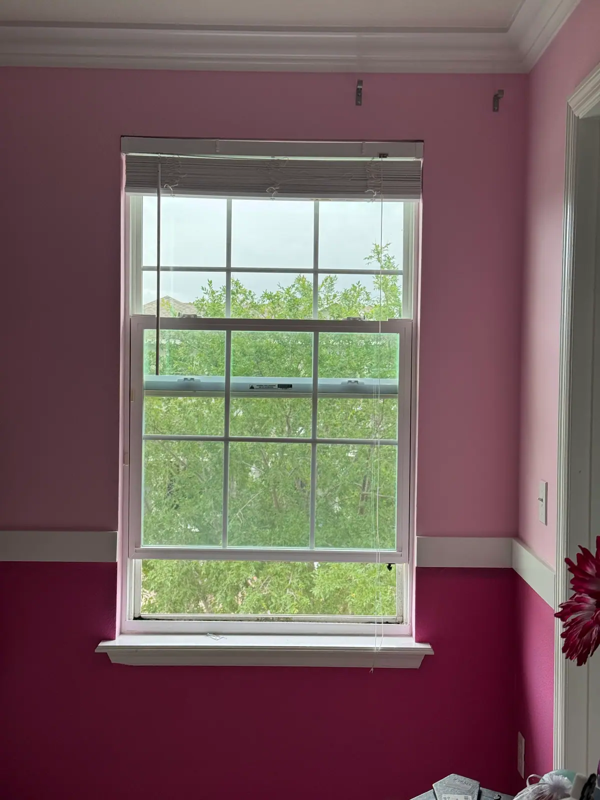 Bedroom painted in two tones of pink with white trim